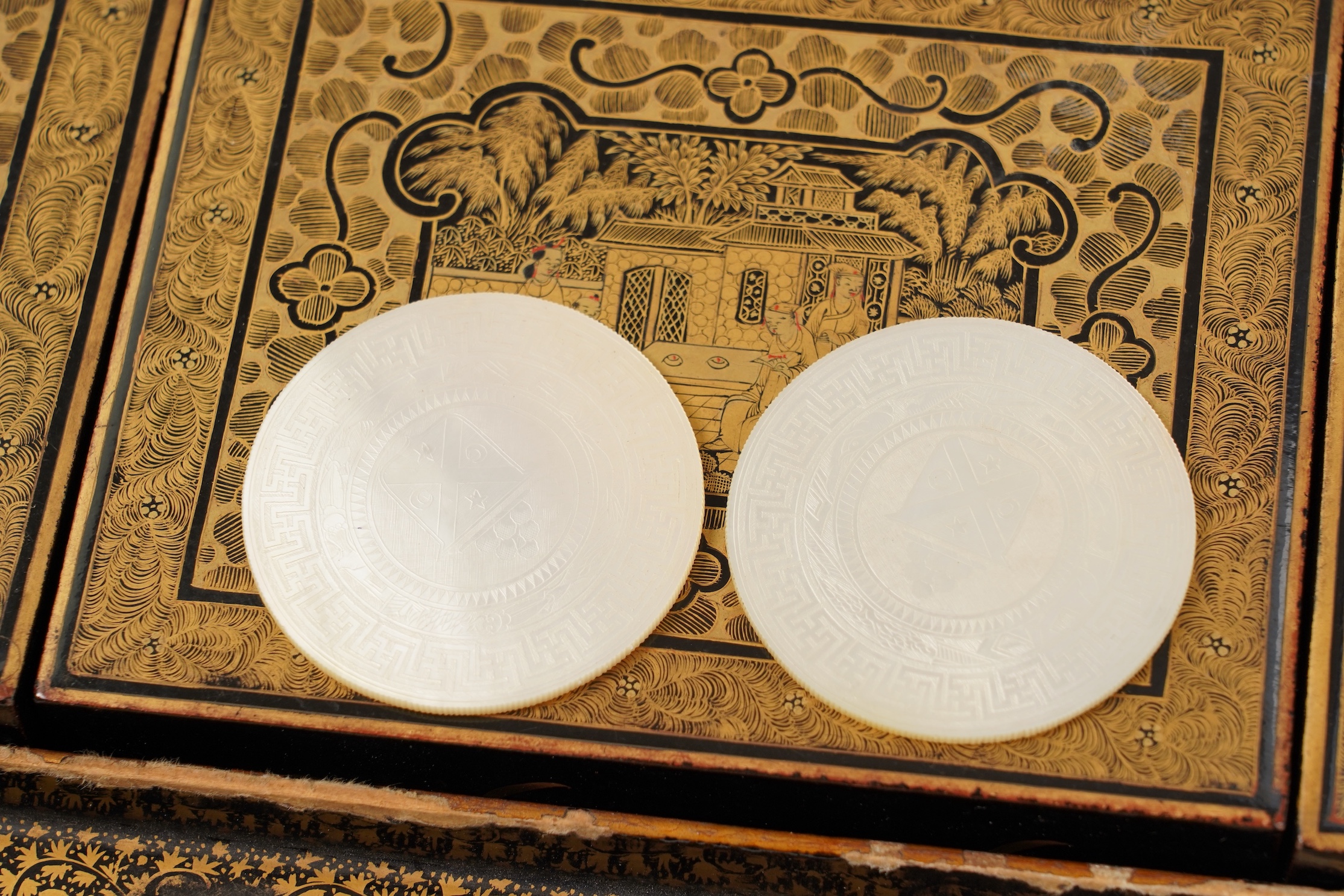 Two Chinese gilt decorated black lacquer games boxes, containing numerous mother-of-pearl counters, 19th century